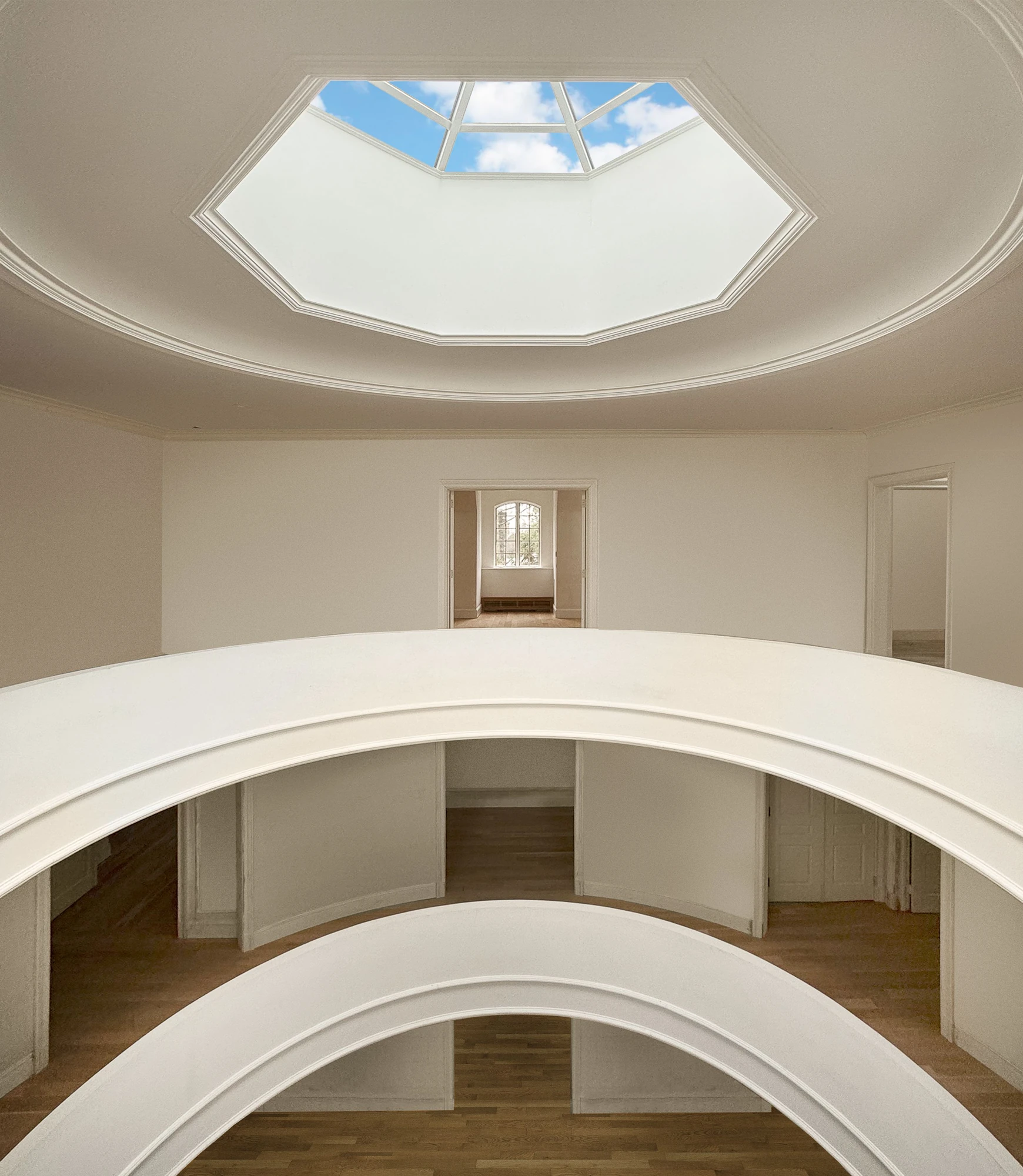 Curved interior balconies surrounding the open atrium at 5040 Independence Avenue