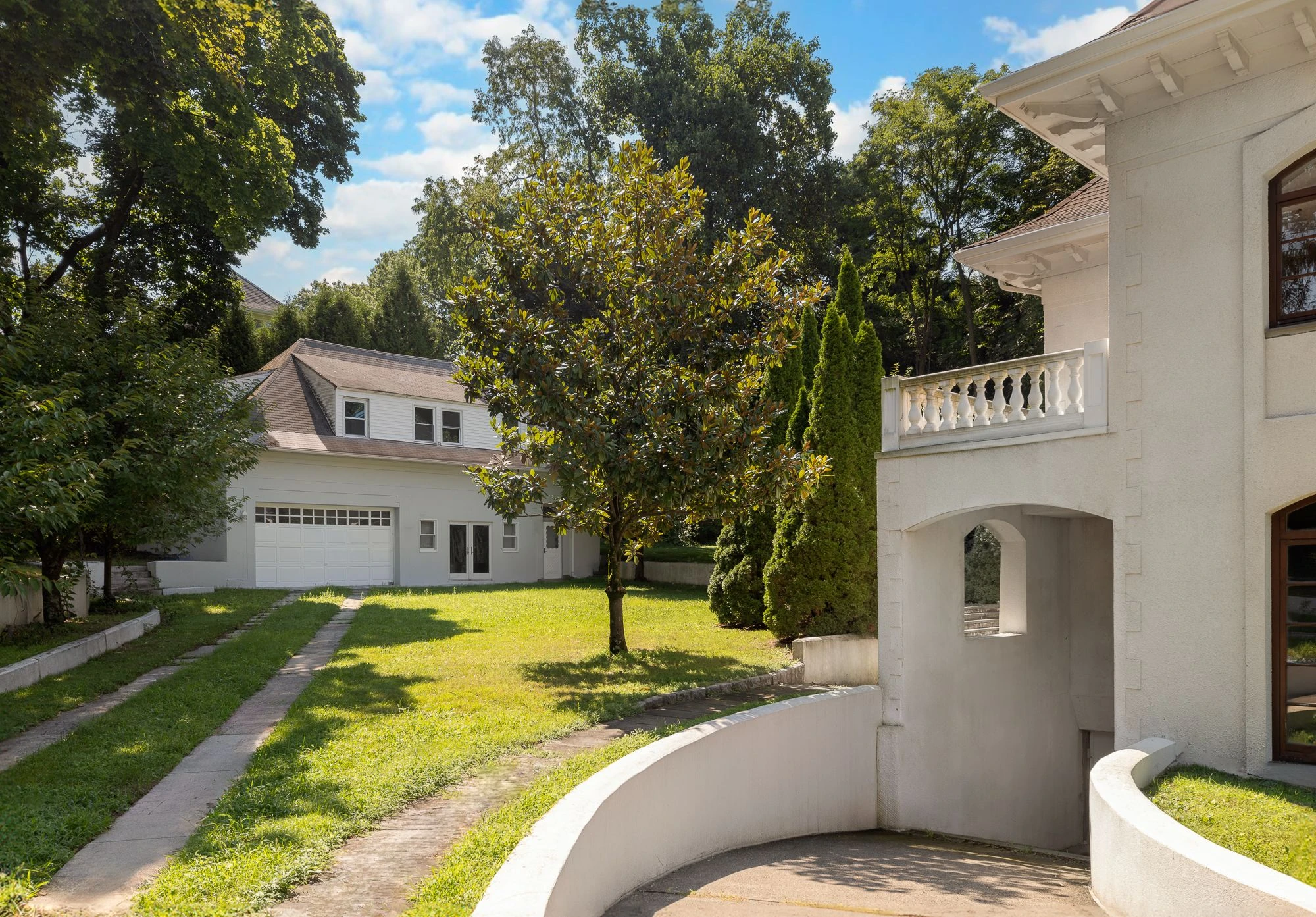 Lawn between the main mansion and a detached cottage and garage at 5040 Independence Avenue
