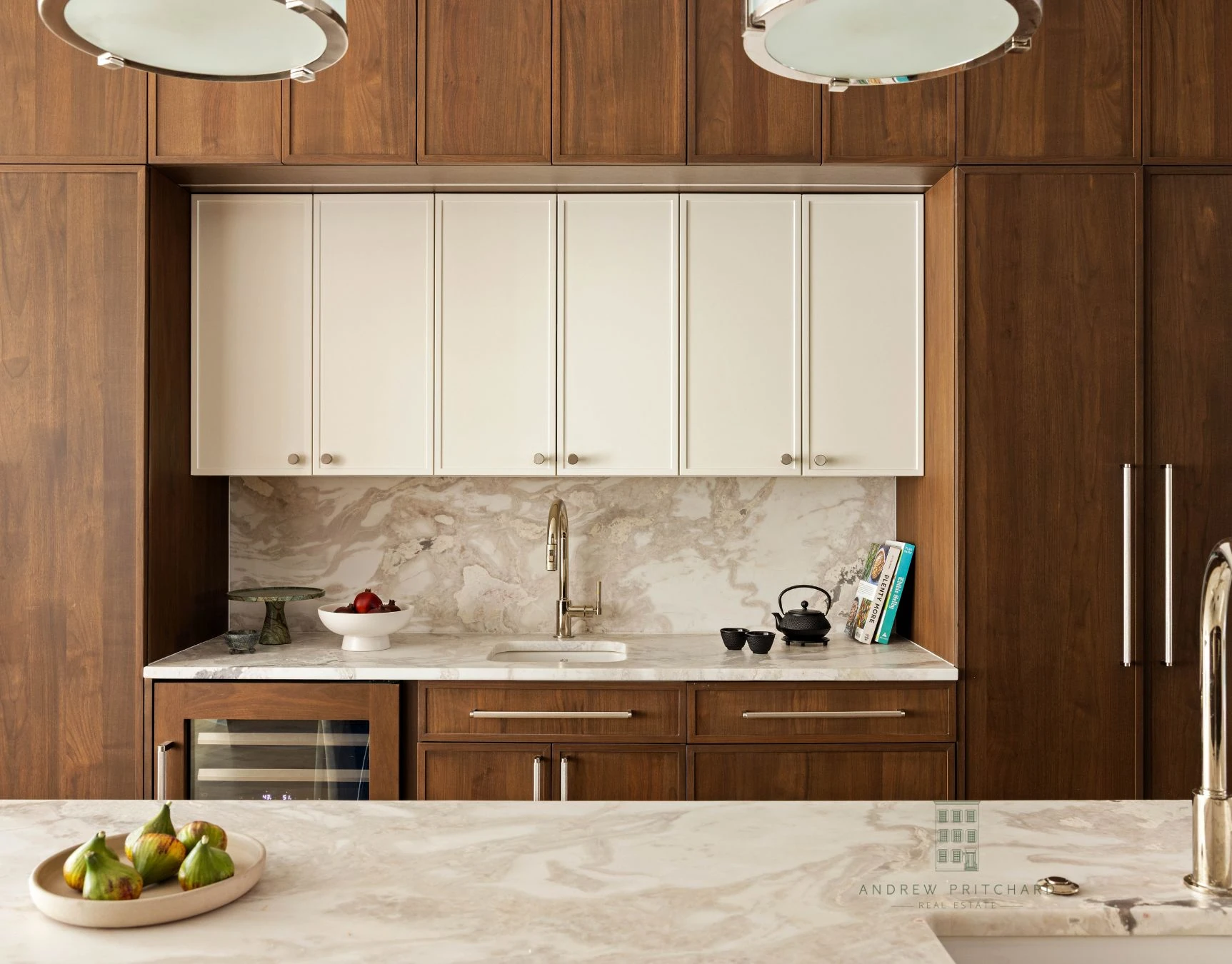 Kitchen wall with dark wood cabinetry, pale marble backsplash, and matching counters at 232 Eighth Street