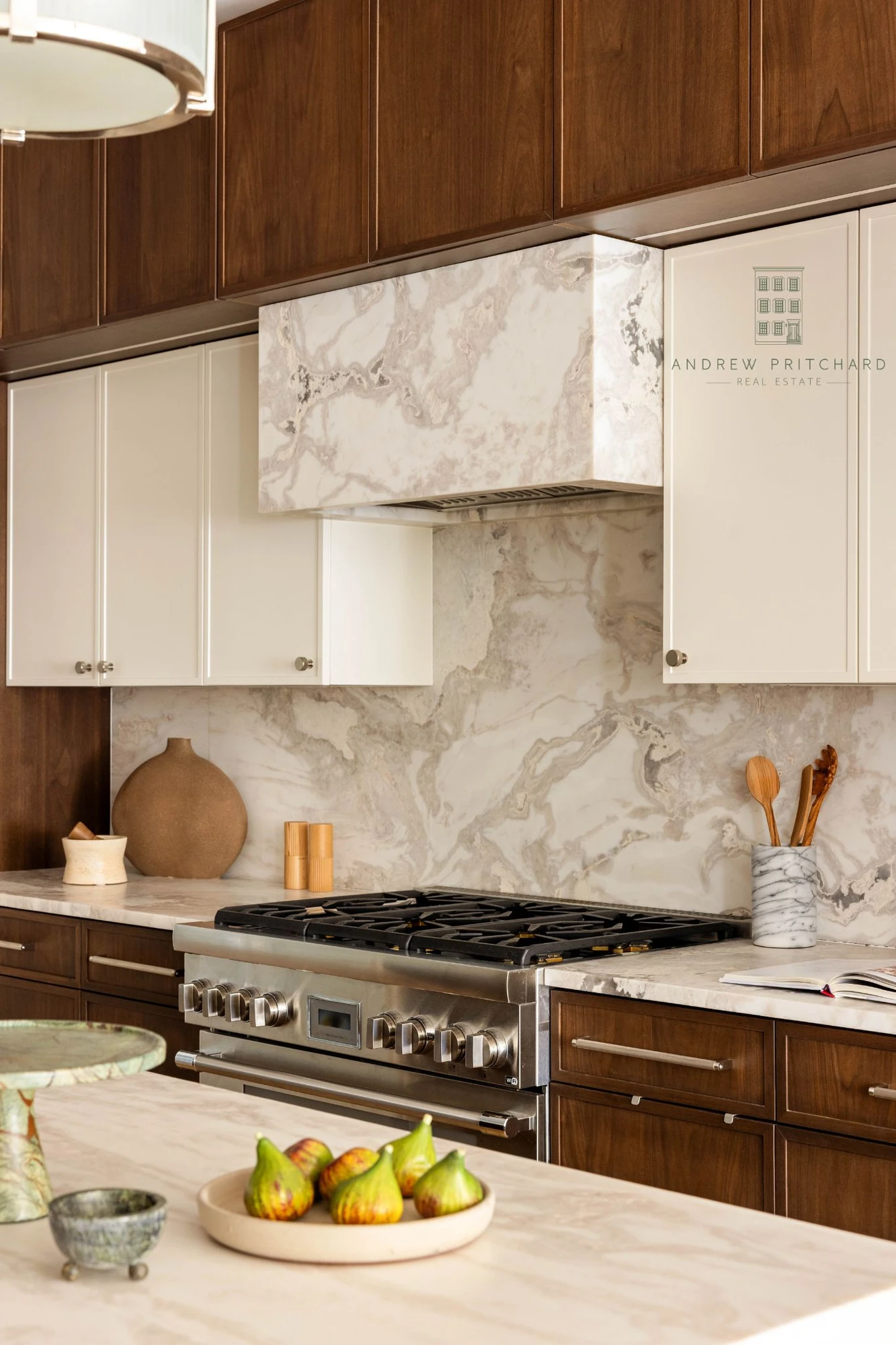 Close view of the marble backsplash and matching marble range hood at 232 Eighth Street