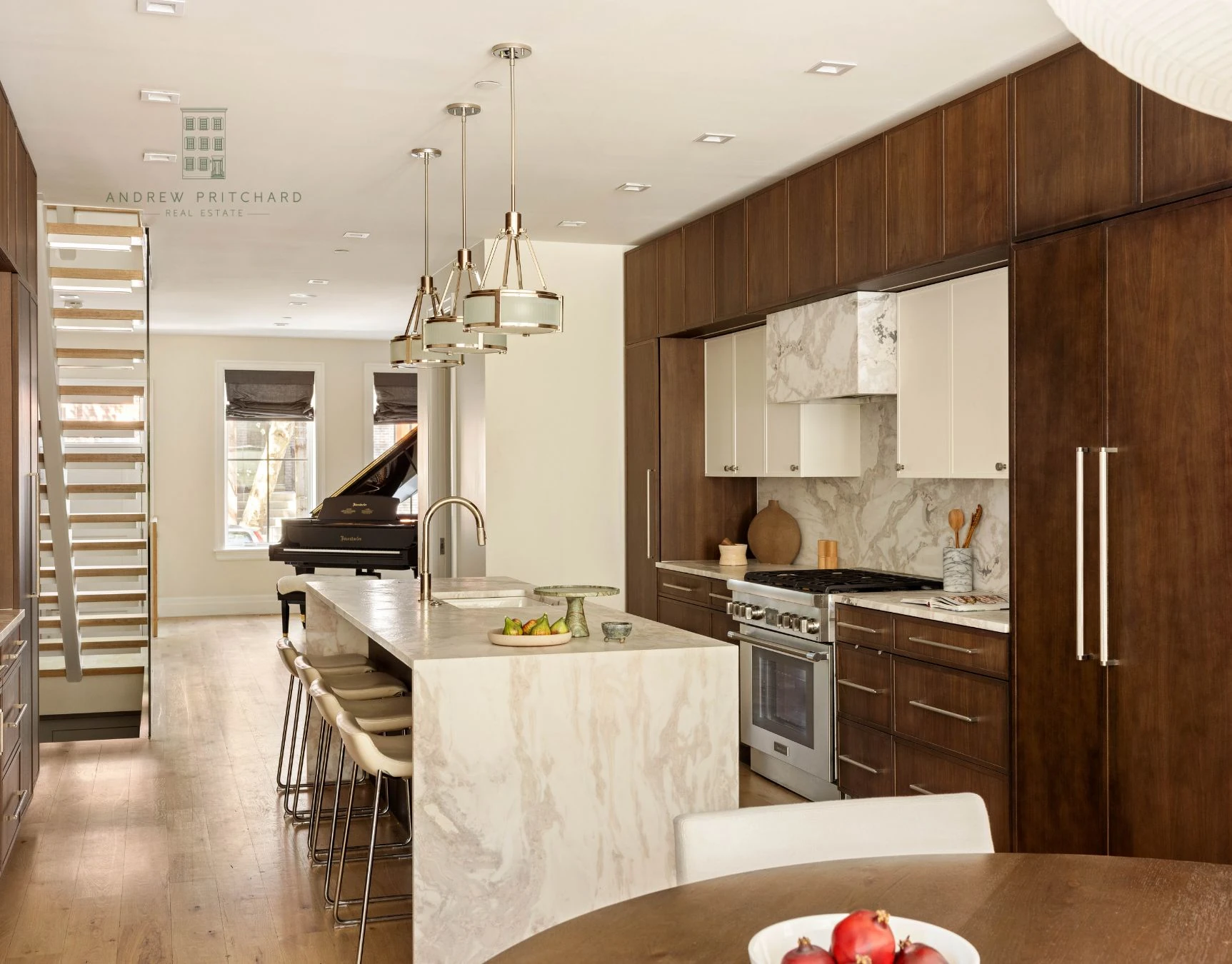 Wide kitchen view with marble waterfall island and dark wood cabinetry at 232 Eighth Street