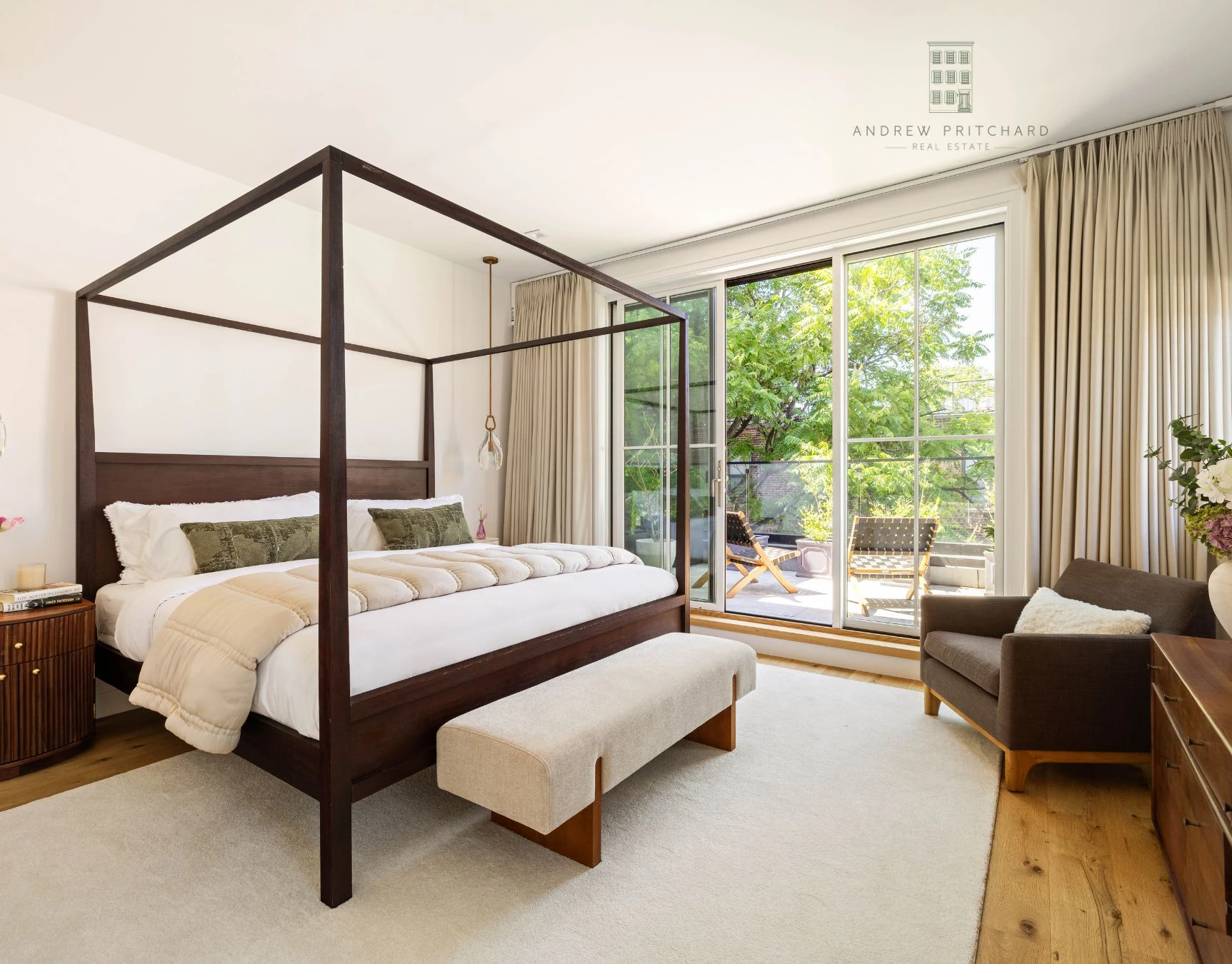 Primary bedroom with canopy bed and glass doors opening to a terrace at 232 Eighth Street