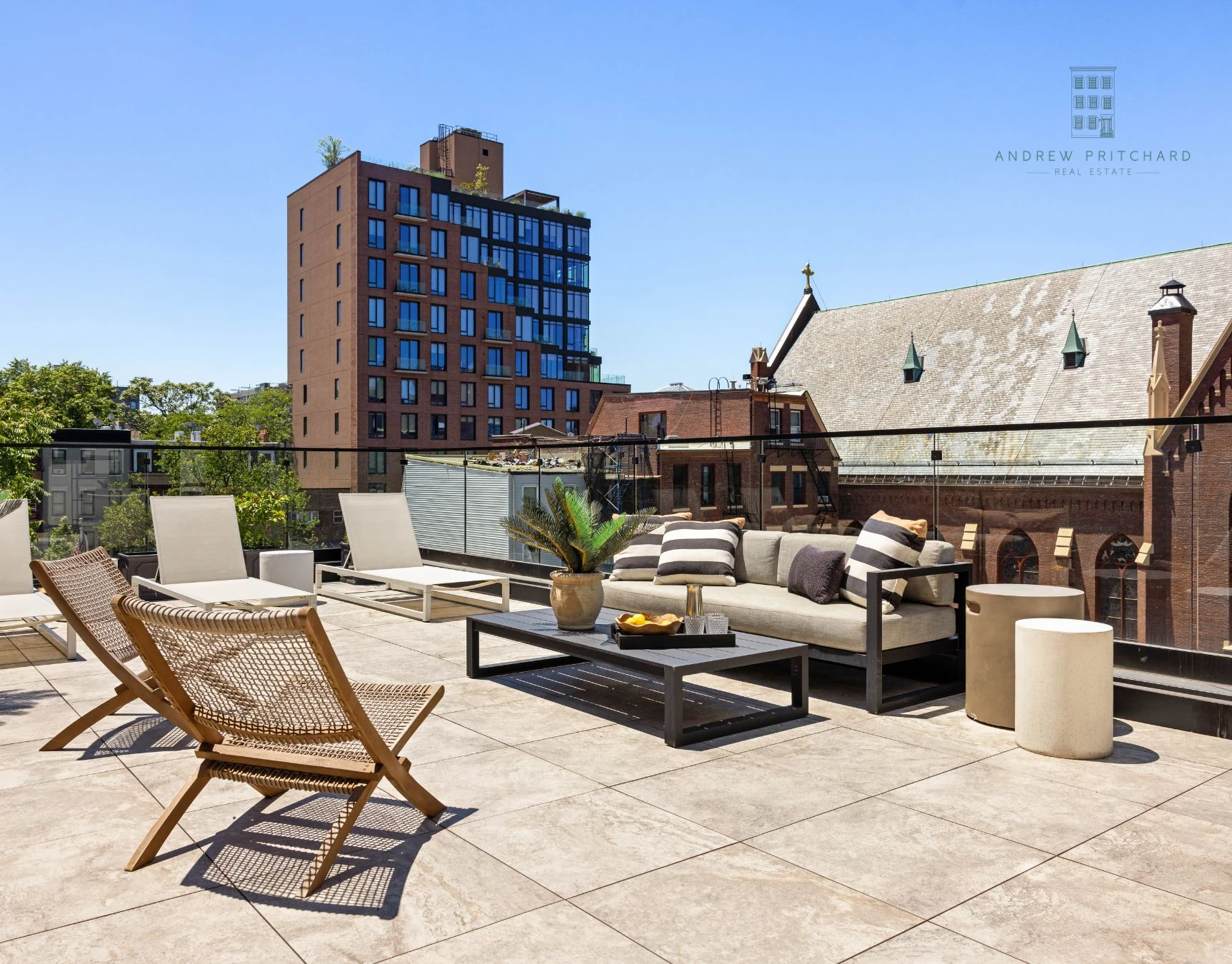 Large roof terrace with lounge seating and neighborhood views at 232 Eighth Street