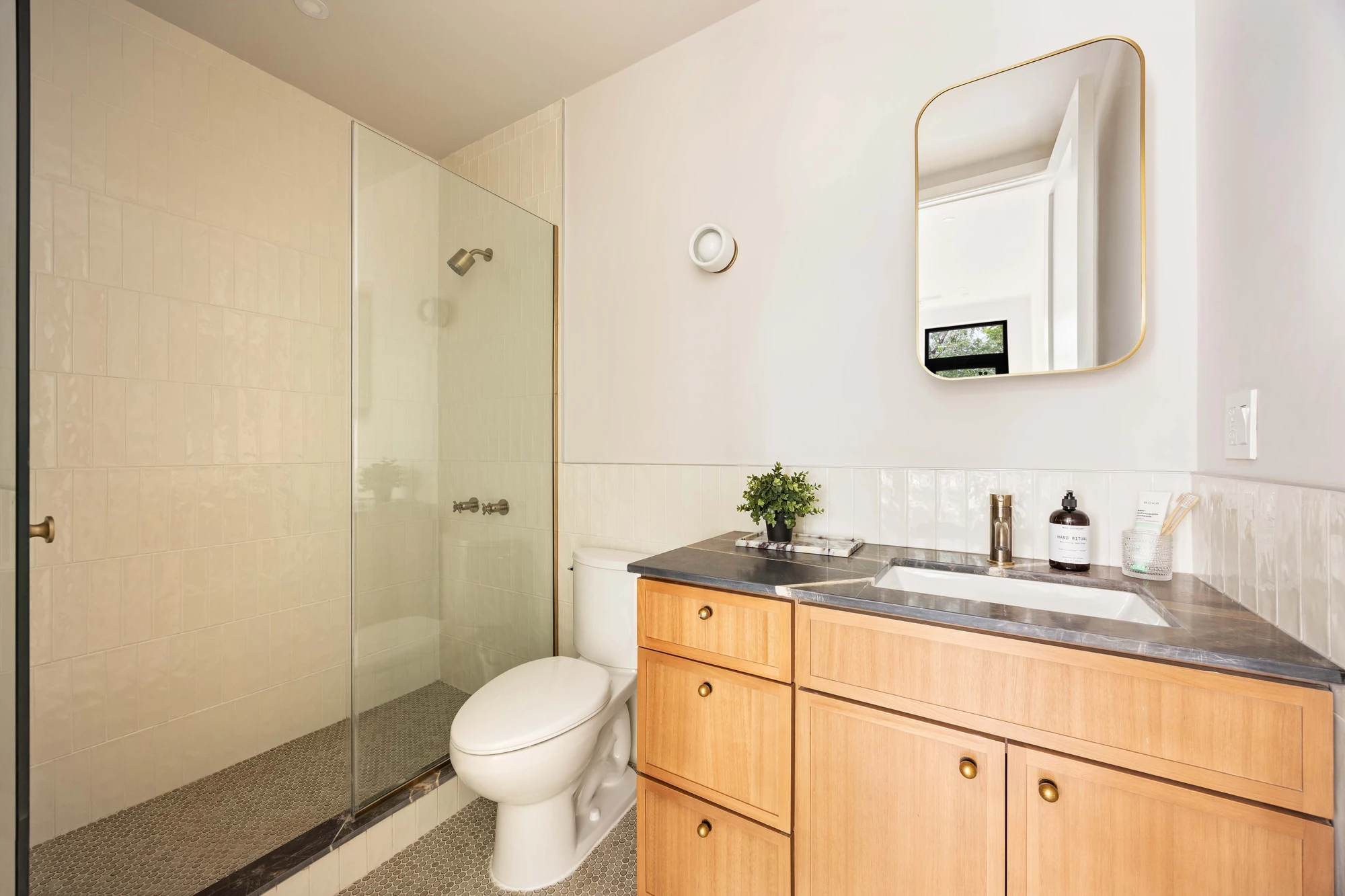 Bathroom with wood vanity and glass shower at 269 Bainbridge Street