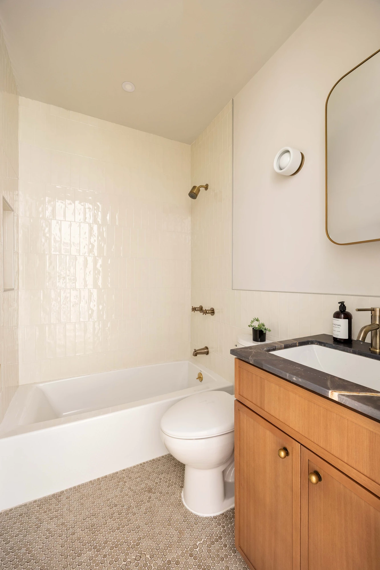 Tiled bathroom with wood vanity at 269 Bainbridge Street