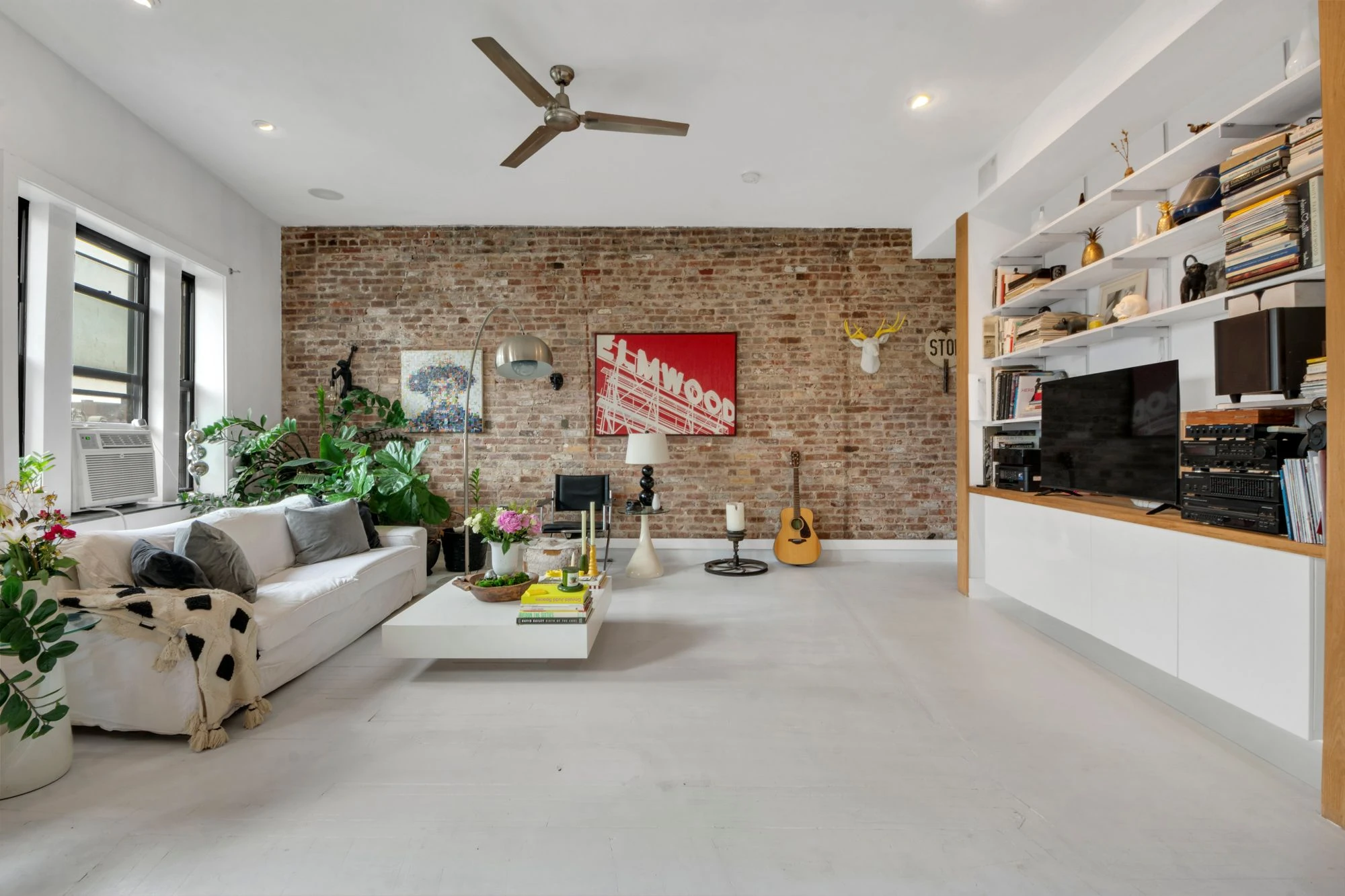 Second living-room view with exposed brick at 47 Fort Washington Avenue