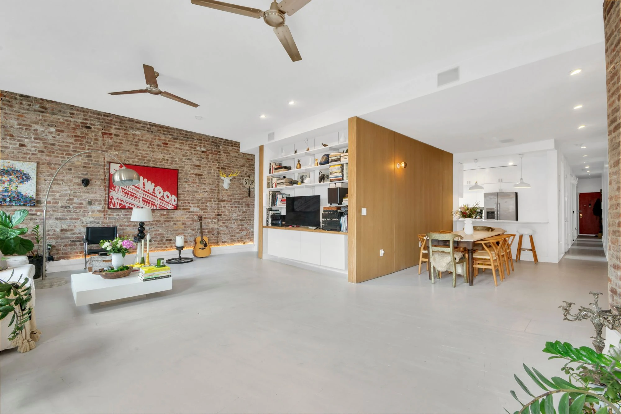 Open living space with exposed brick at 47 Fort Washington Avenue