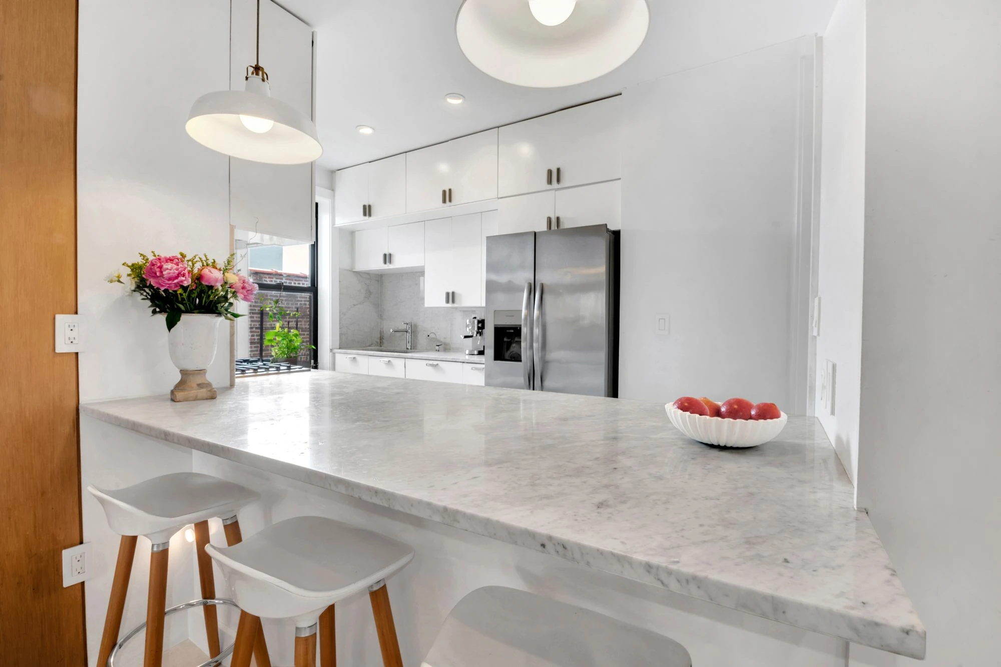 White kitchen with marble counters at 47 Fort Washington Avenue