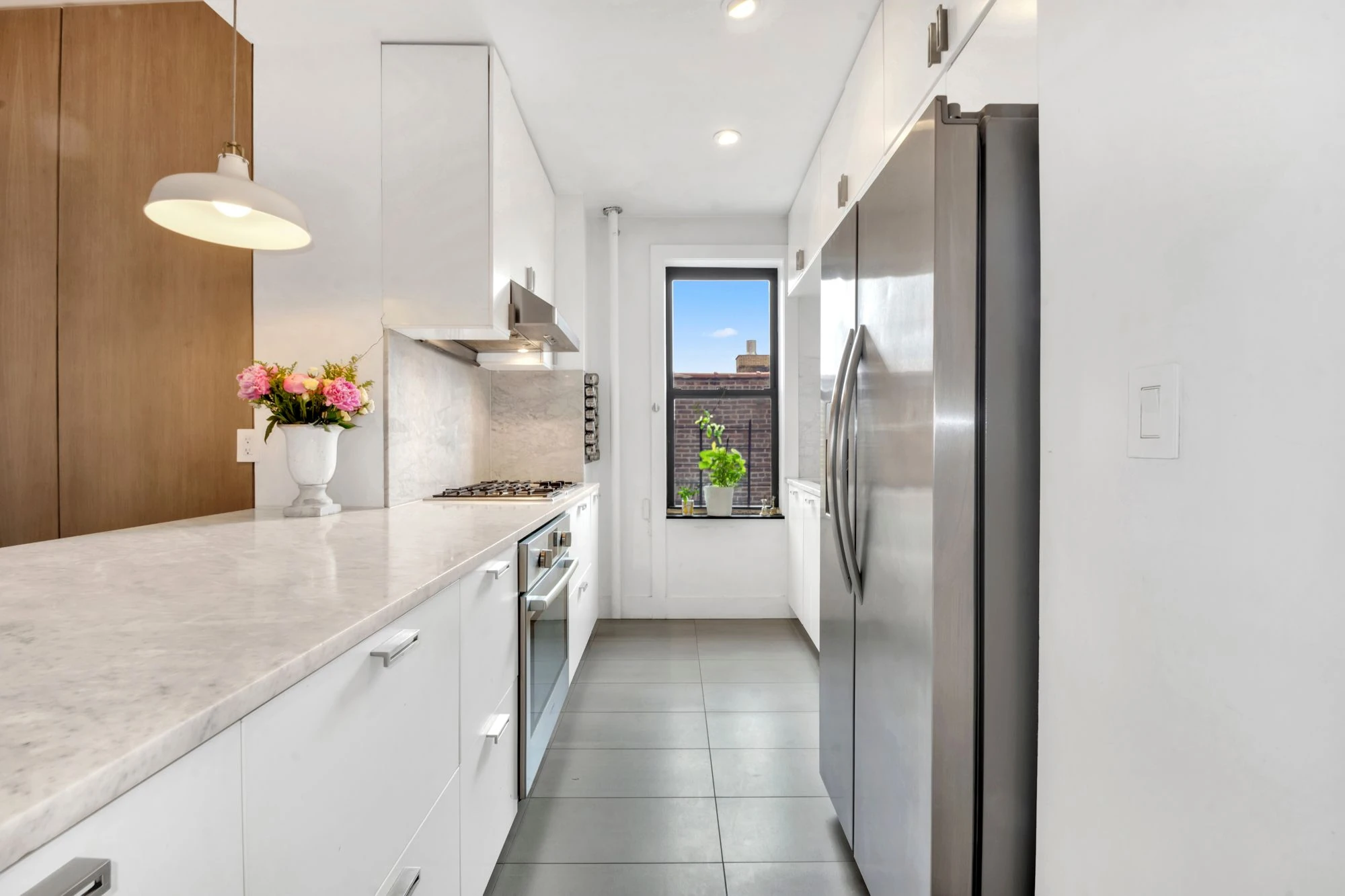 White cabinetry and marble counters at 47 Fort Washington Avenue