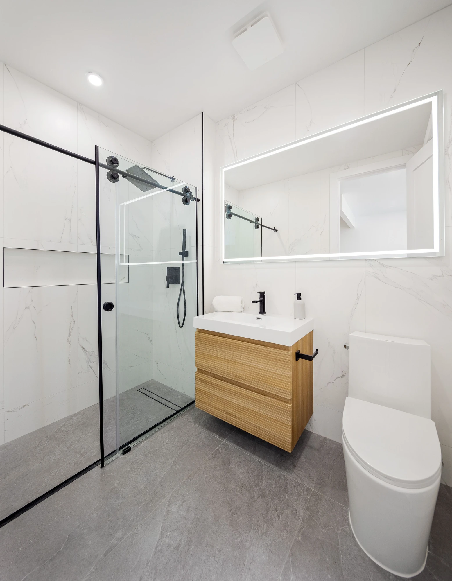 Minimal bathroom with marble-patterned walls at 301 Stockholm Street