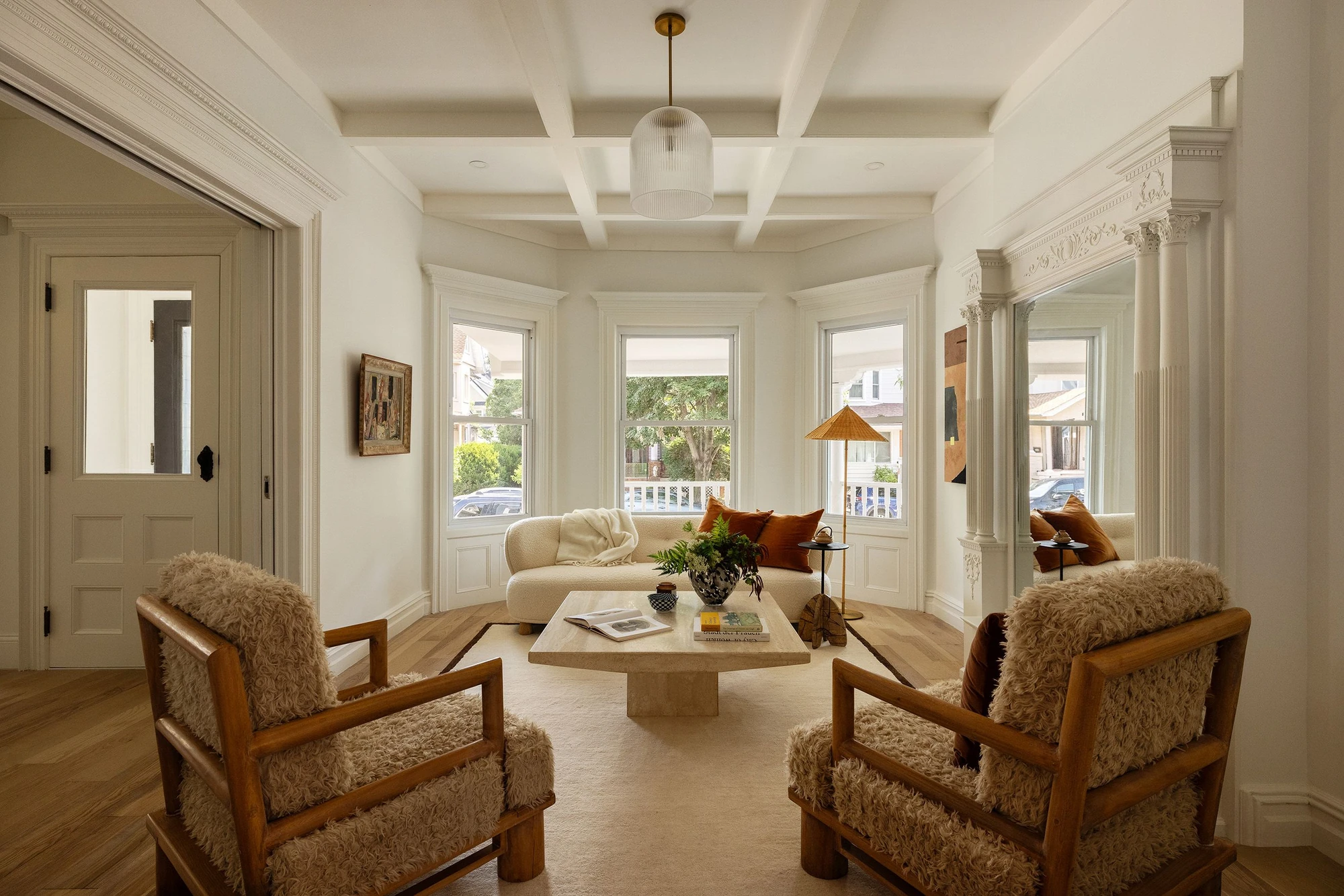 Front living room with bay windows, a coffered ceiling, and ornate millwork at 534 East 24th Street
