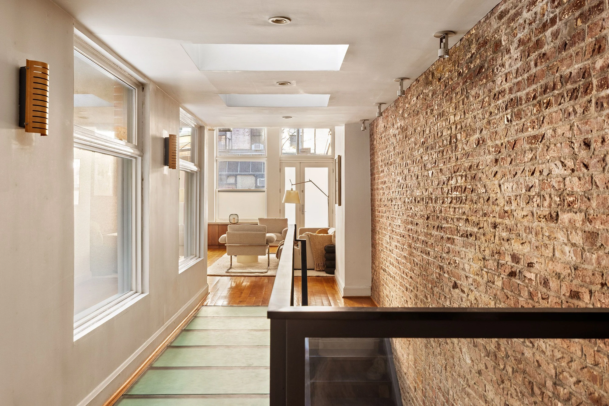 Long hallway beside a textured brick wall at 62 Beach Street