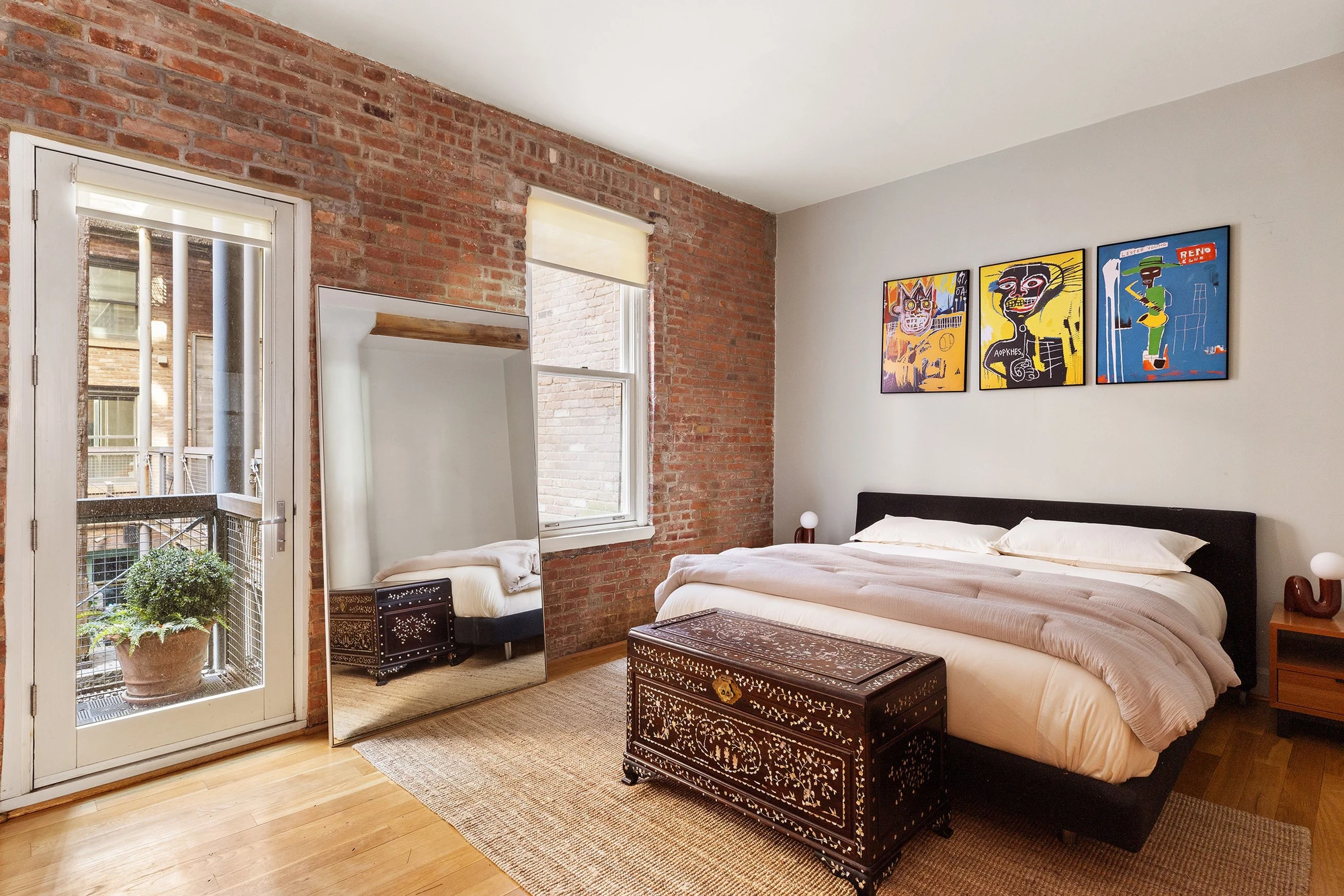 Bedroom with an exposed brick wall and glazed doors at 62 Beach Street