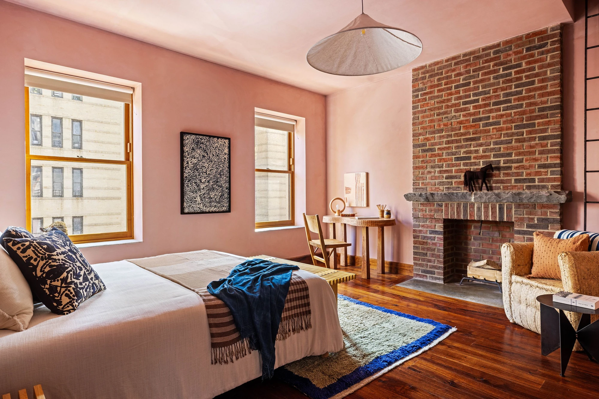 Pink bedroom with a large exposed-brick fireplace at 497 Saint John's Place