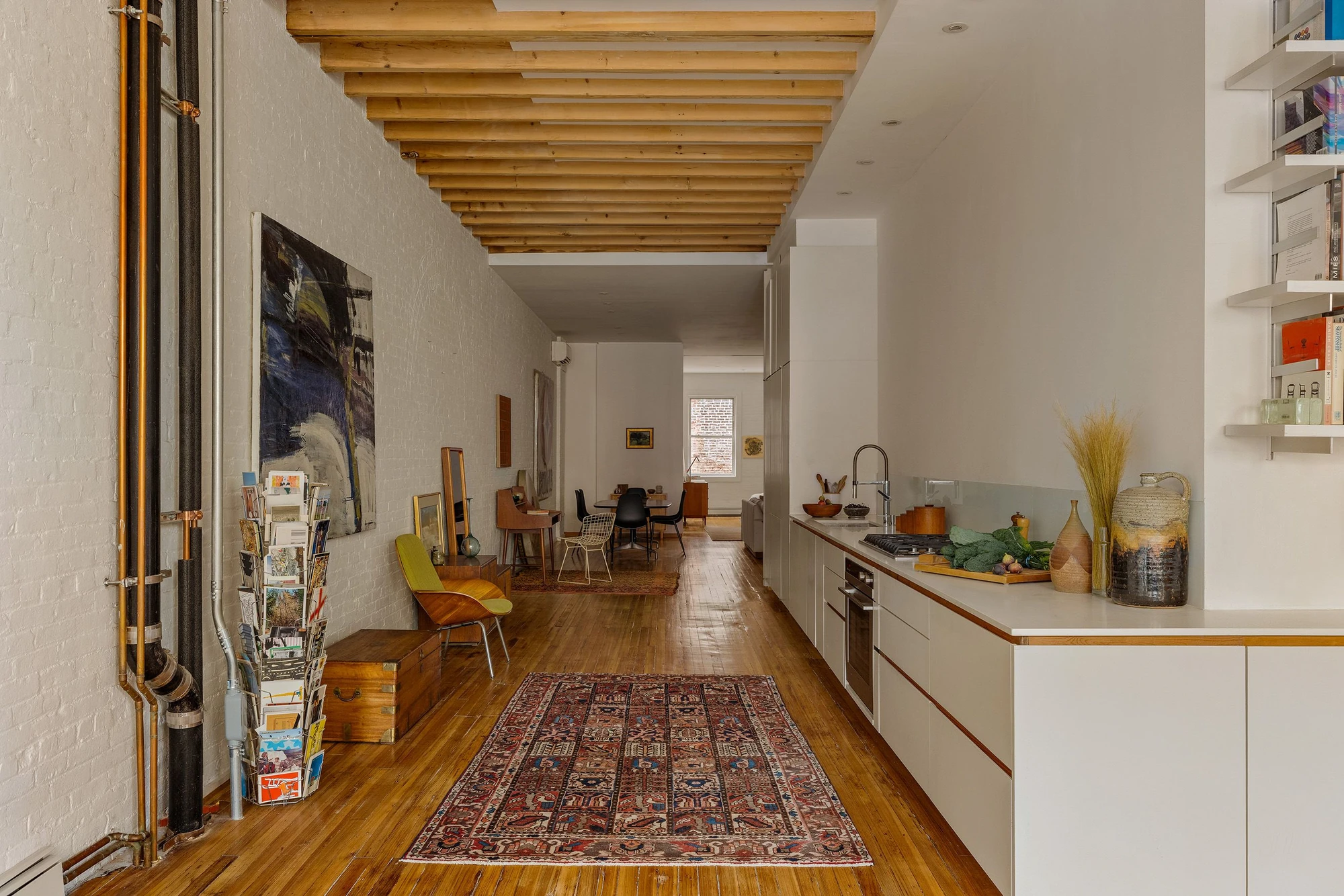 Reverse view through the open kitchen beneath timber ceiling beams at 62 Washington Avenue