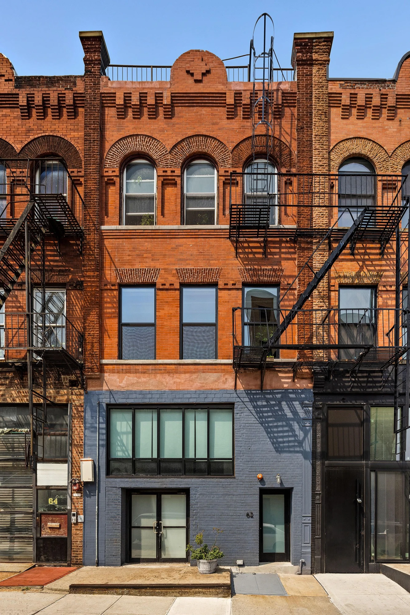Red-brick building with arched upper windows at 62 Washington Avenue