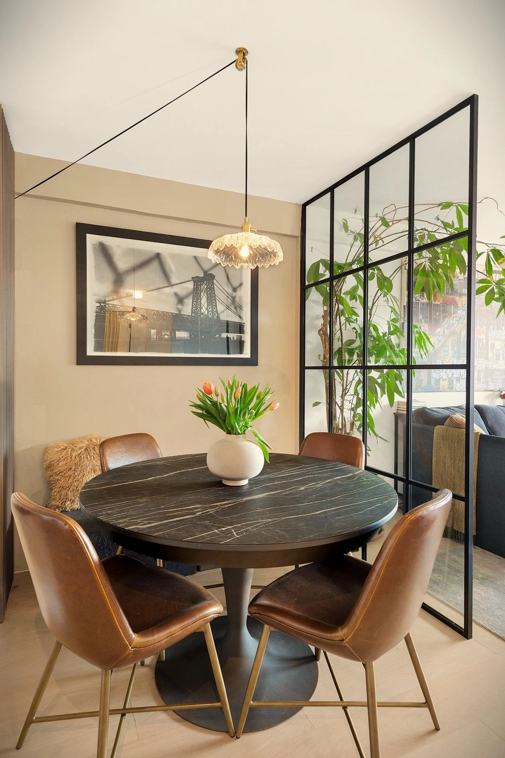 Dining table beside a glass interior partition at 90 Gold Street #21F