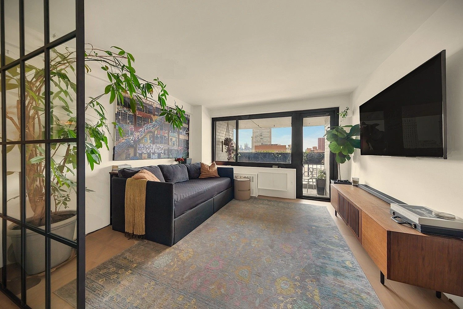 Living room opening to the balcony at 90 Gold Street #21F