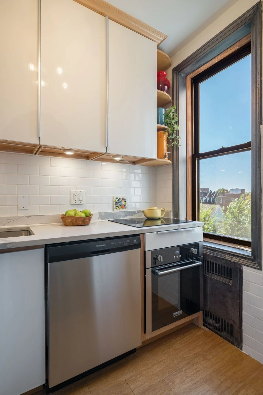 Windowed kitchen with white upper cabinets at 1710 Avenue H #C5