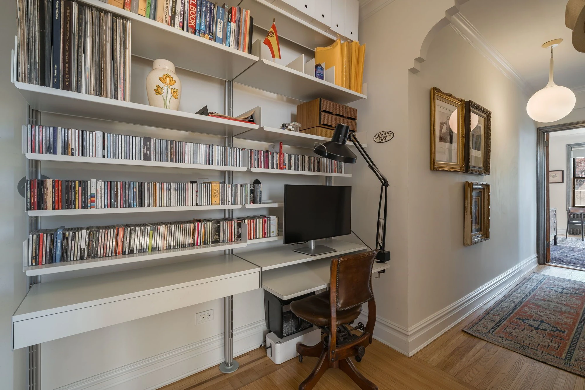 Desk tucked beneath built-in shelving off the entry at 1710 Avenue H #C5