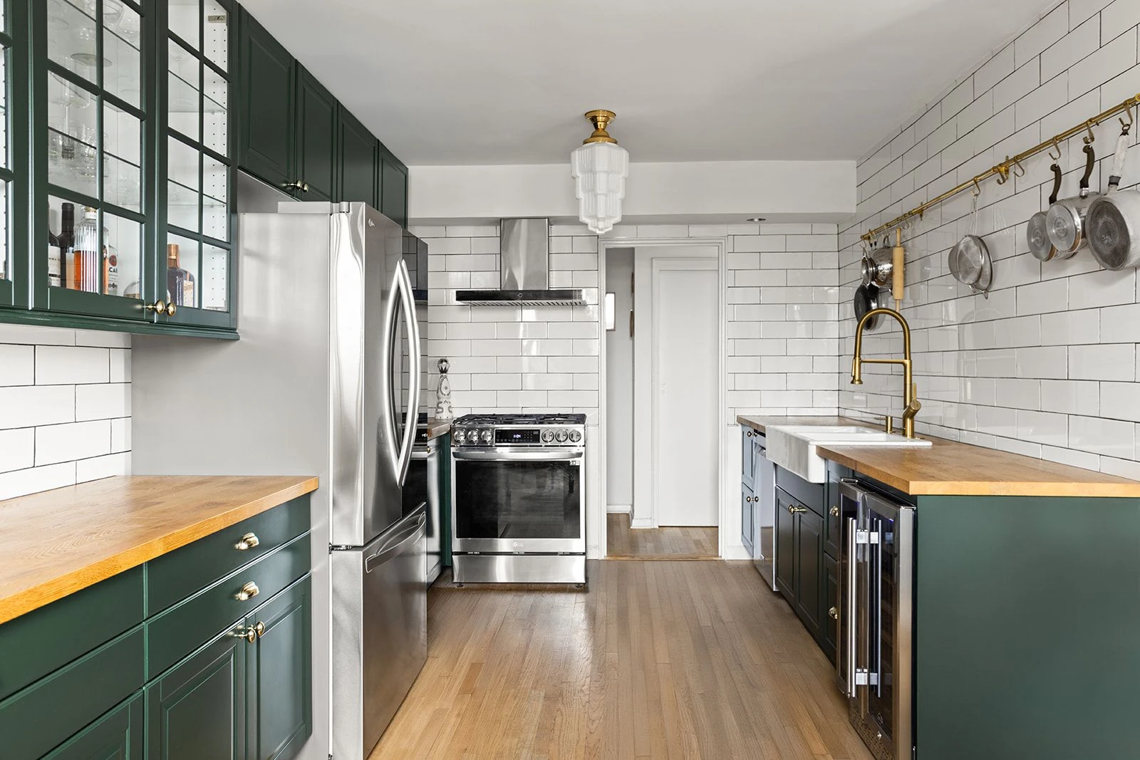 Green cabinetry, wood counters and stainless steel appliances at 34-43 60th Street #4DE