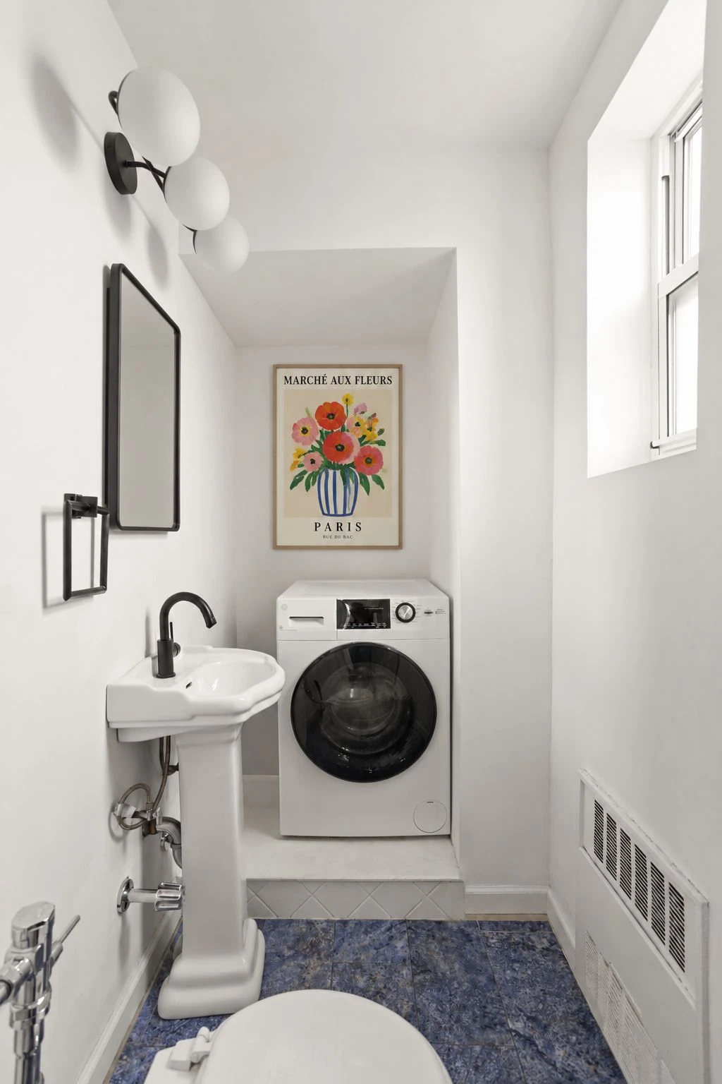 Washer and dryer in the half bathroom at 34-43 60th Street #4DE
