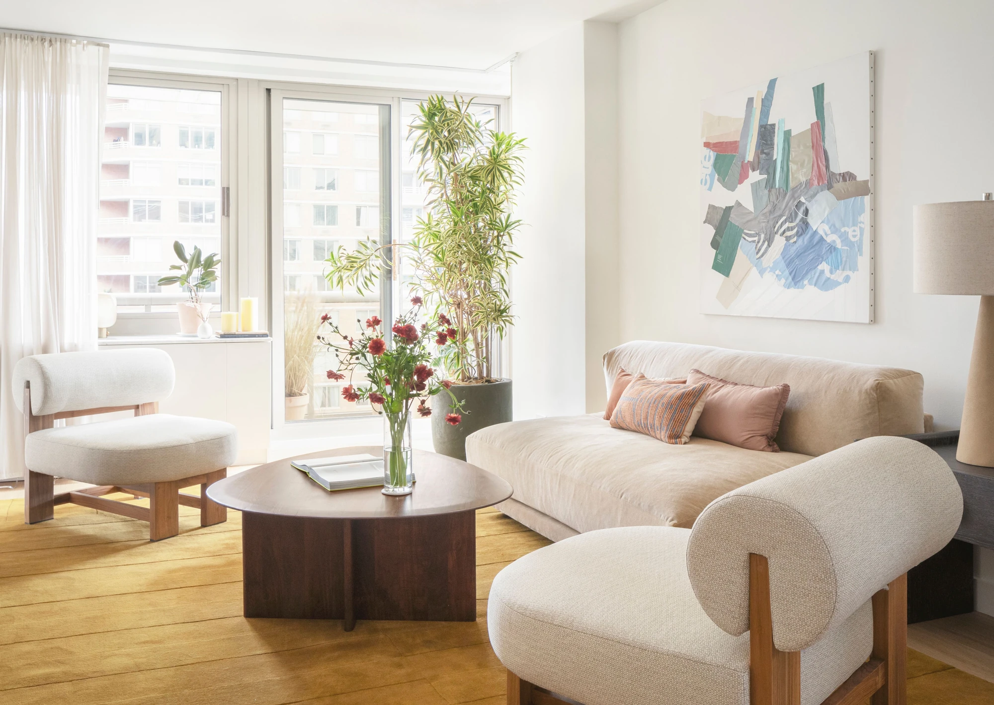 Seating area with wide windows and pale wood flooring at The Perrie, 234 East 46th Street #701
