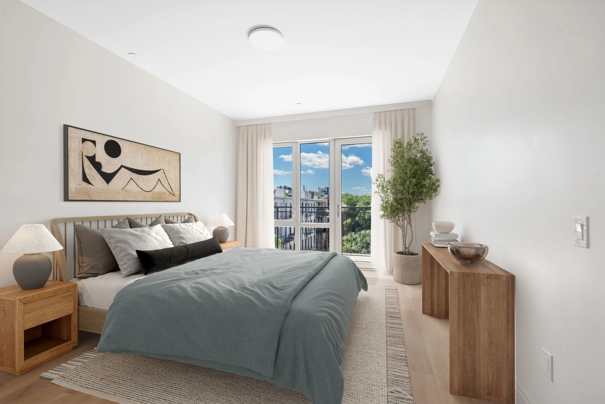 Bedroom with pale wood floors and a glazed door to its balcony at 222 16th Street #4C