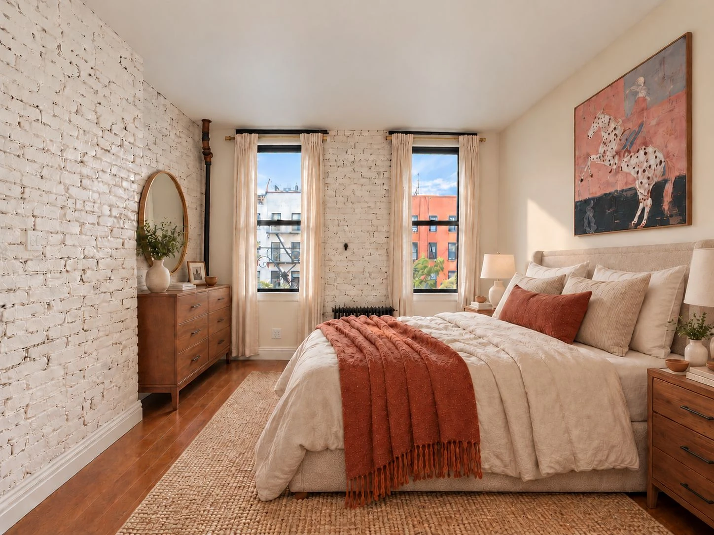 Bedroom with painted white brick and two windows at 646 Ninth Avenue #4FS
