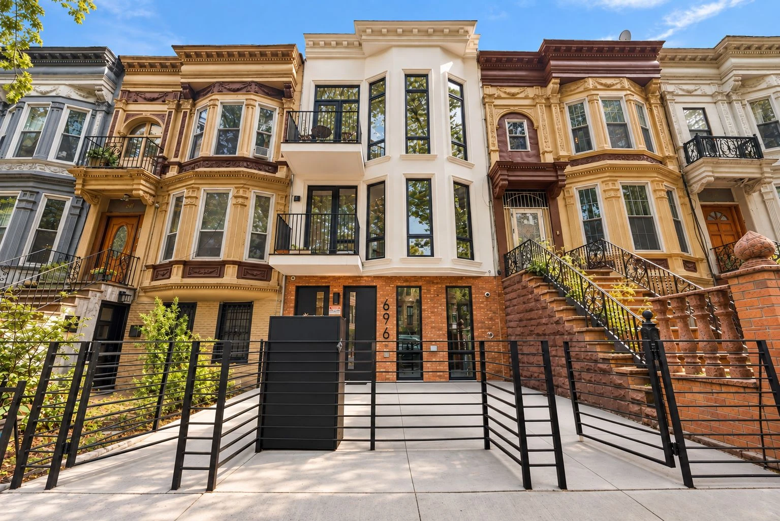 Supplied building image of a barrel-front Brooklyn facade with a stoop; developer image package carries a rendering disclosure at 696 Chauncey Street #1