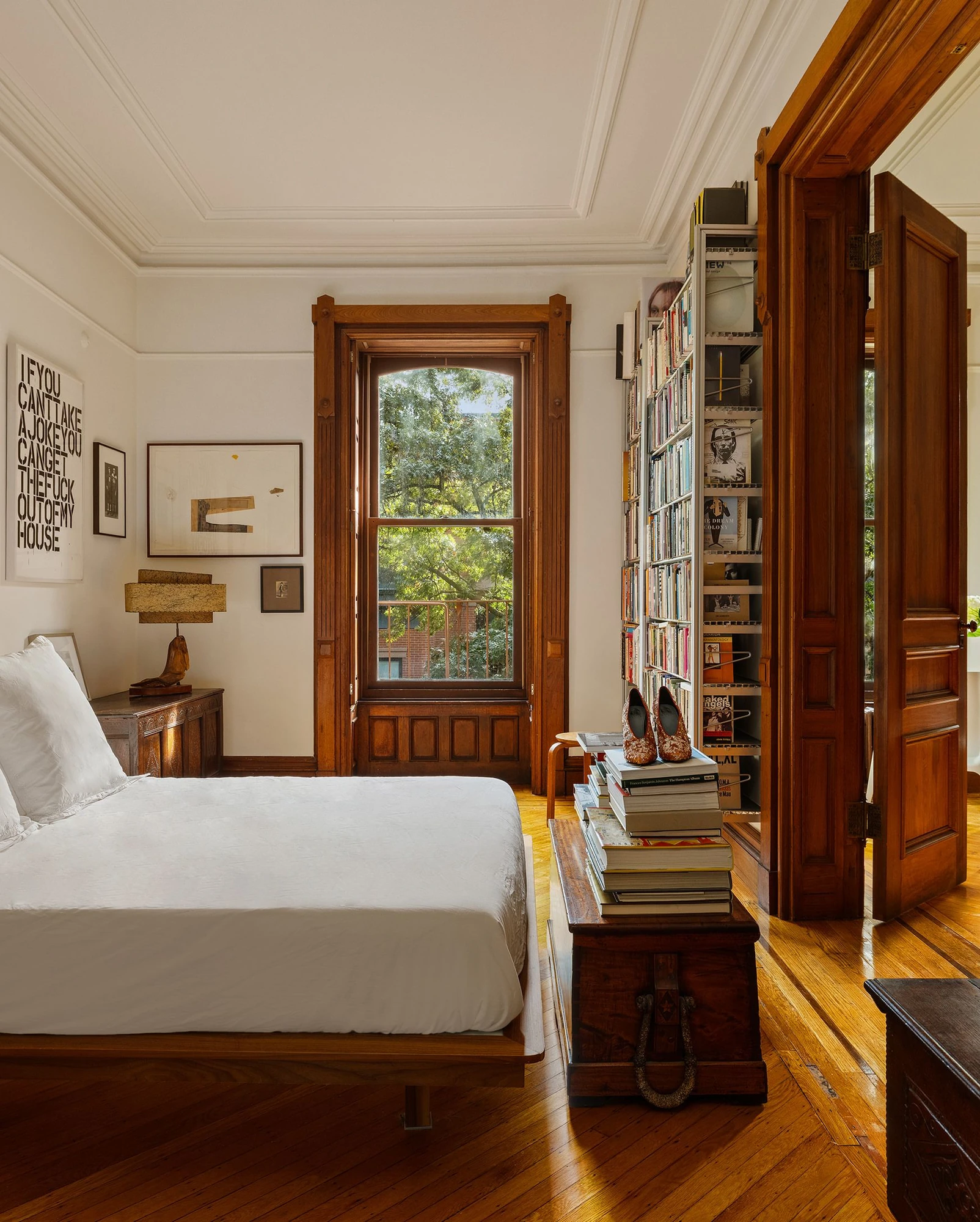 Bedroom with wood-framed windows and a large doorway at 39 Remsen Street #4A